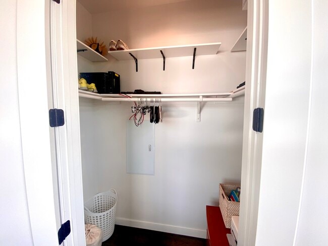 The walk-in closet provides ample hanging space and shelving above. - 1501 E 4th St