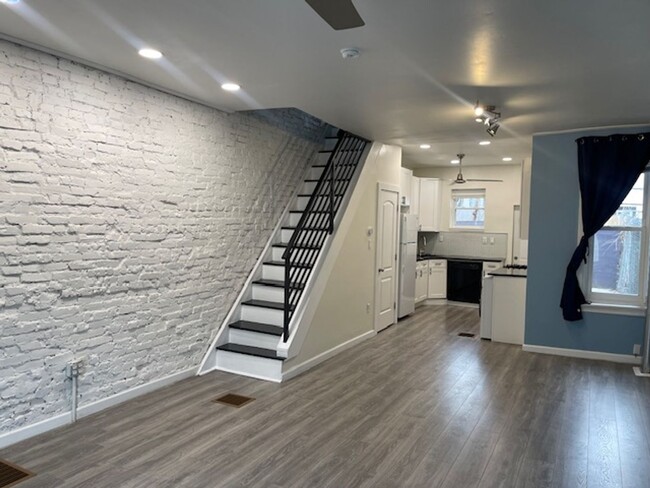 Primary Photo - Modern 3-Bedroom Home with Exposed Brick &...