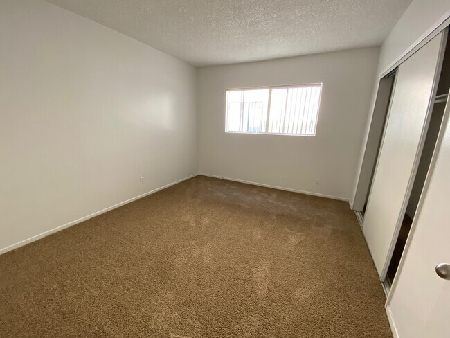 Bedroom has new carpet. - 1731 N Normandie Ave