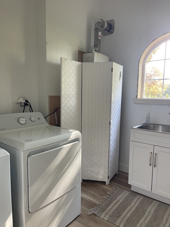 Laundry room with new appliances and spacious half bath - 13440 Perry Ln