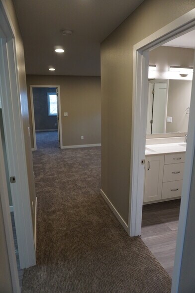 Looking to the upper level full bath (Photos are of similar unit with similar finishes.) - 3811 Stacy Drive