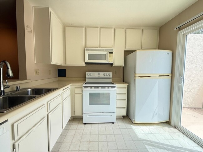Building Photo - Move in Ready! 2BD Townhome! New Carpet! Two Patio Spaces! Attached Garage!