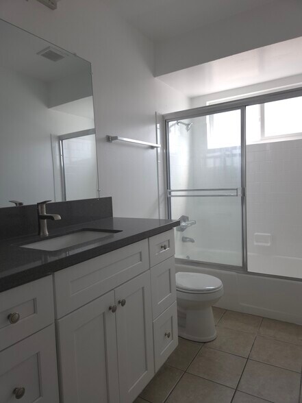 Hall bathroom with quartz countertop and Shaker cabinets - 3455 Elm Ave
