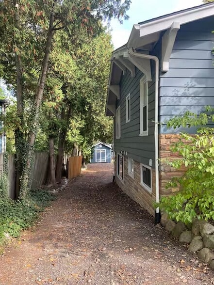 top of driveway looking down to backyard, through gate, where apartment entrance is - 1622 Pear St