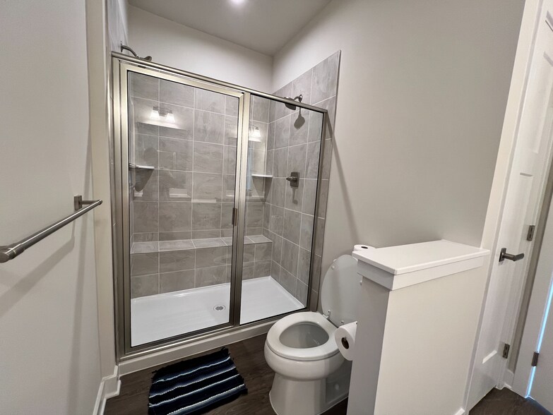 bathroom with large shower with a built-in seat. - 5957 Jefferson Technology Blvd