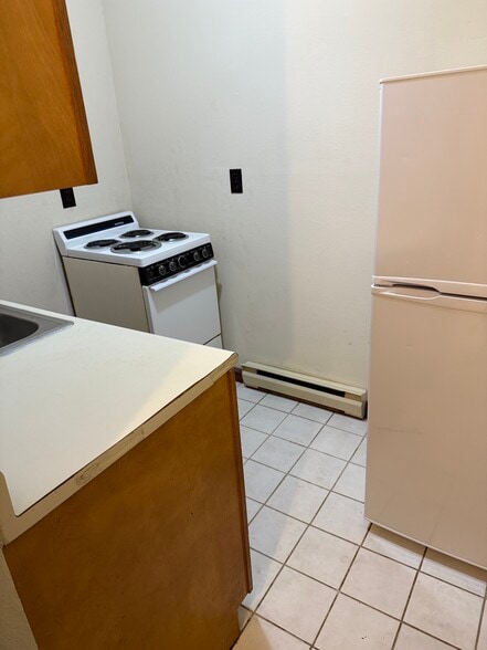 Kitchen area. Counter, fridge and stove - 1810 7th Ave