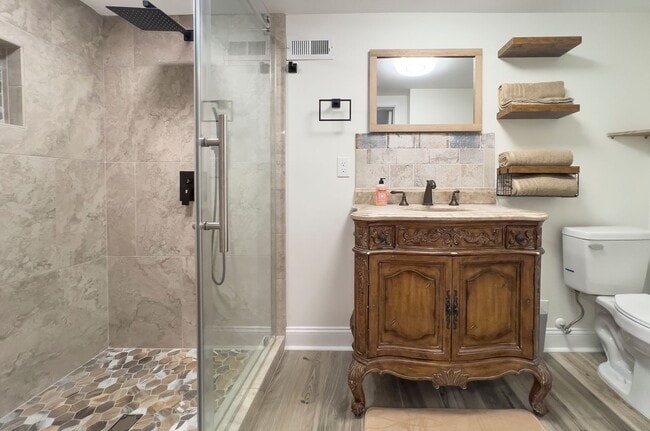 Building Photo - Discover the charm of this FULLY FURNISHED basement unit, tucked away in a beautifully updated bu...