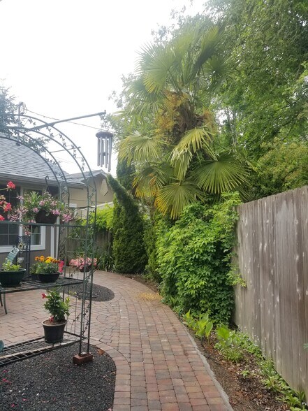 Sun-facing patio with custom pavers added several yrs ago; plant stand not included - 885 Randall St