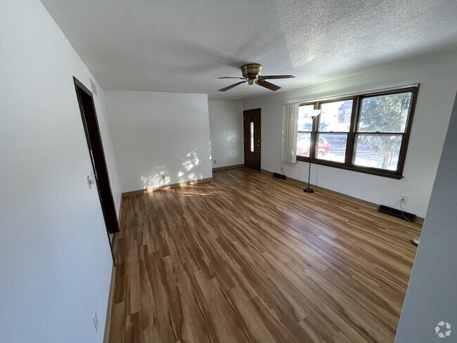 Living room, with large window, looking at front door. - 715 Westgate St