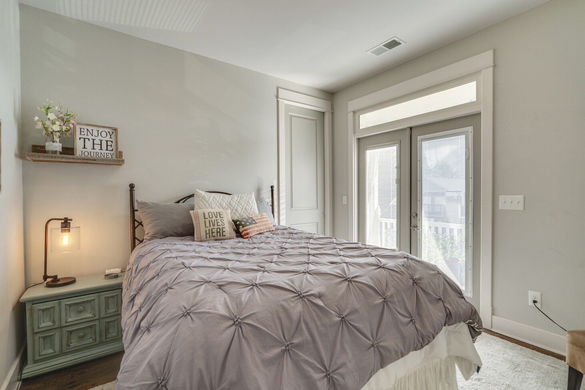 3rd Bedroom with Large Walk in Closet and walk out balcony with seating and Privacy Curtains - 1922 14th Ave N