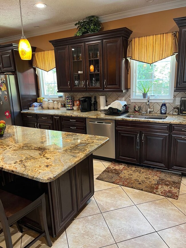 Building Photo - Updated & Landscaped 4 Bedroom, 4 Bath Hom...