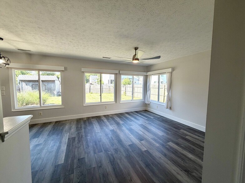 Light filled living area with large windows overlooking the back yard. Modern, high end ceiling fan - 1200 Bugle Bluff Ct
