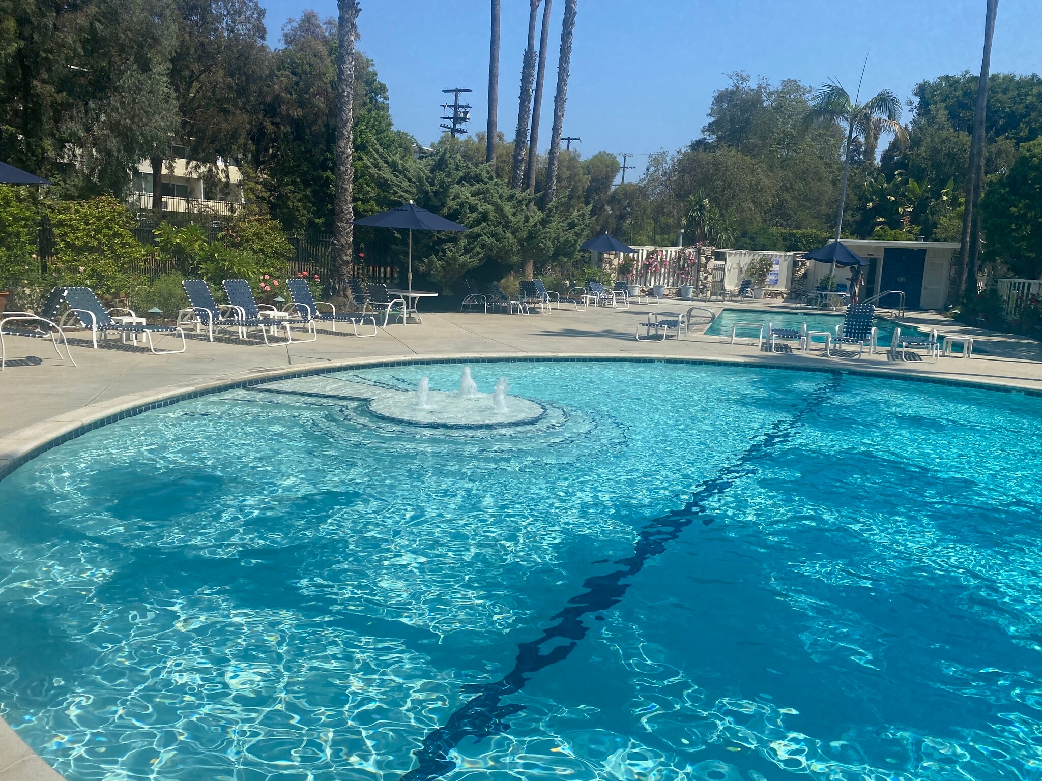 Circular pool with fountain - 241 S Barrington Ave