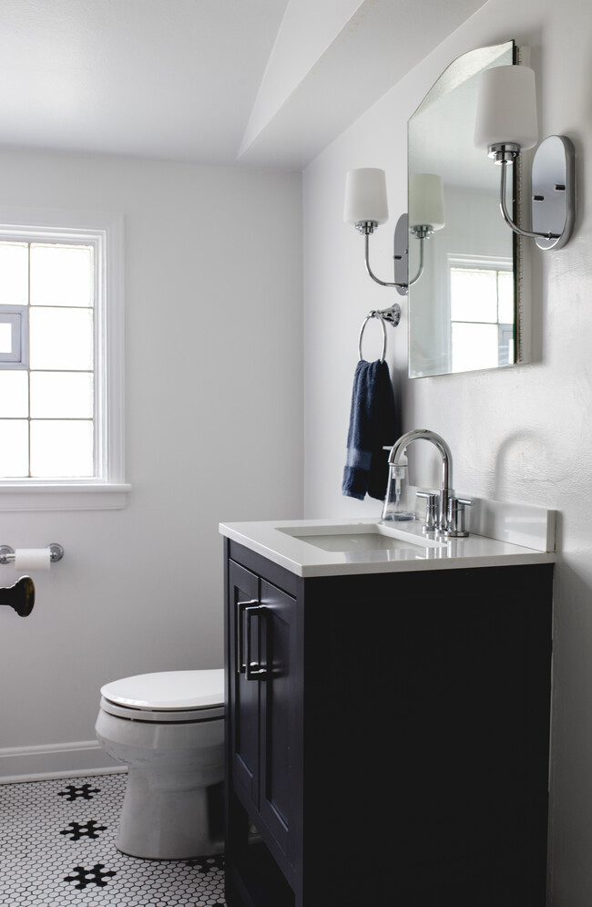 Updated bathroom with new toilet, vanity, lighting and fixtures, and tile floor. - 4242 N Olsen Ave