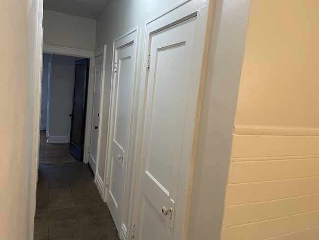 Hallway leading to the bedrooms and bathroom as well as the back stairwell with 2 closets - 5033 Devonshire Ave