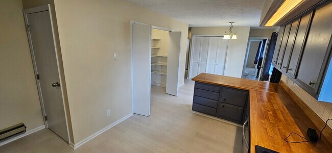 Kitchen with view of pantry near the middle and the half bath on the right. - 578 Tyler St