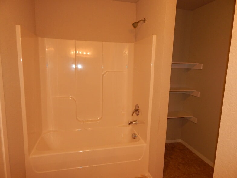 Primary bathroom has shower/tub and extra storage. - 5074 W Claxton Circle