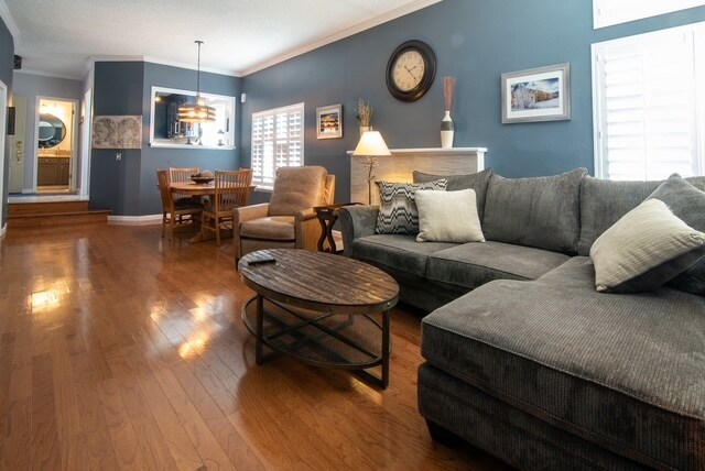 Dining and living room with shutters and hardwood floors - 5555 E Briarwood Ave