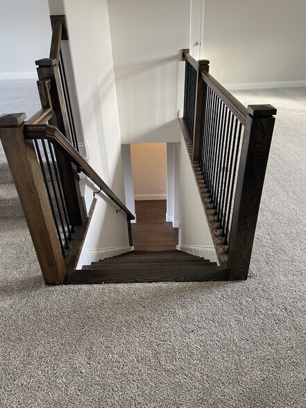 wood staircase with wrought iron railing - 1026 October Park Way