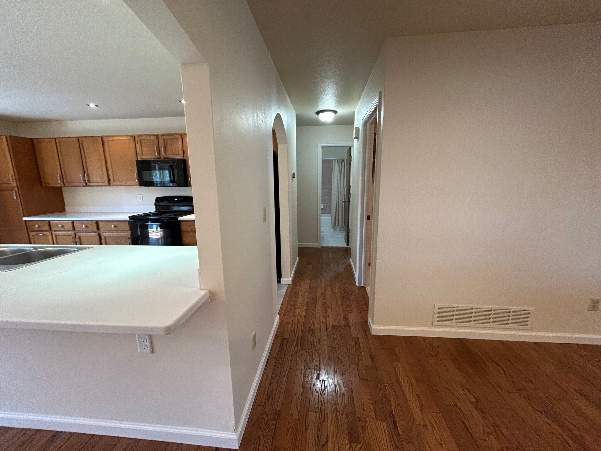 Hallway to laundry room, bathroom, and two additional bedrooms - 4393 N Lincoln Ave