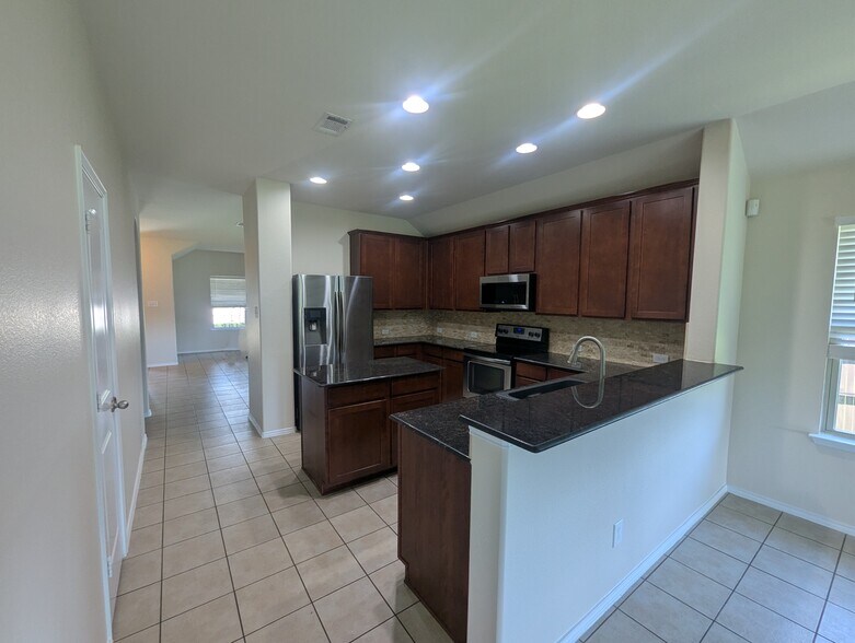 Kitchen with refridgerator, stove, oven/stovetop, and island - 2853 Waterfall Ln