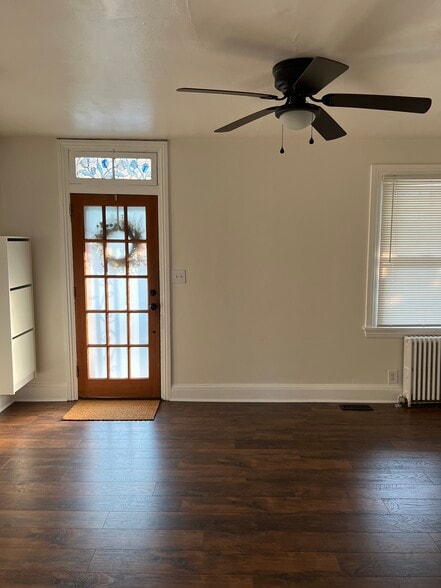 The front door opens into a spacious front room. A shoe organizer is conveniently placed. - 126 Merion Ave