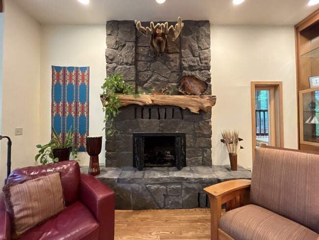 Building Photo - One-of-a-Kind Custom Home with Wall of Windows, Stone Fireplaces, Expansive Entertainment Space &...