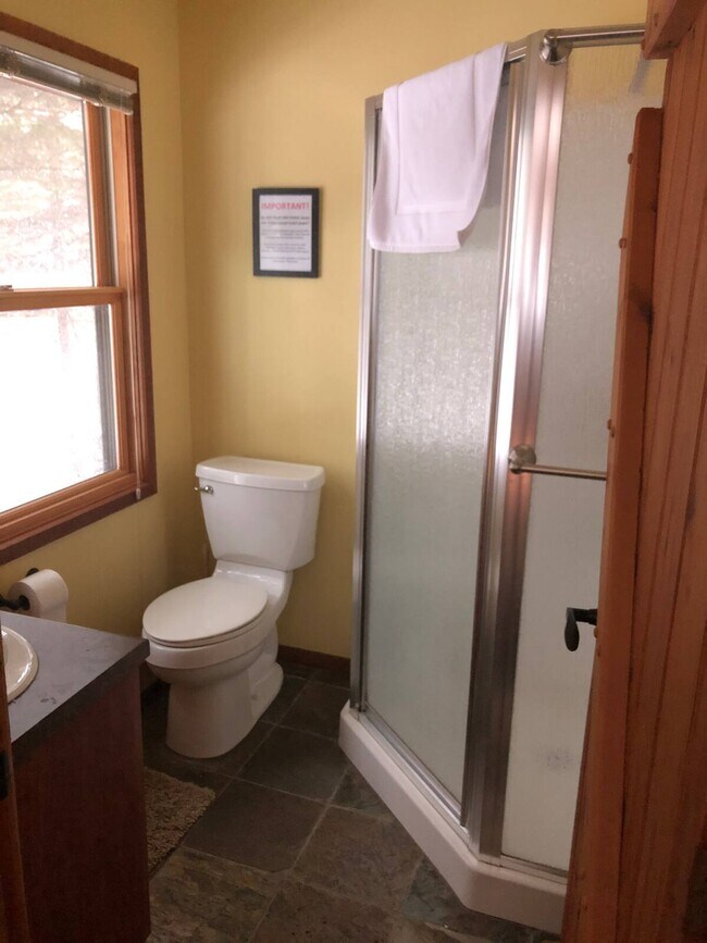 The bathroom has been updated with white paint, and has a view of Lake Superior out the window - 6012 Highway 61