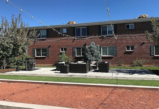 Enjoy outdoor living in this charming apartment setting, complete with cozy seating and beautiful landscaping. - Wadsworth Station West