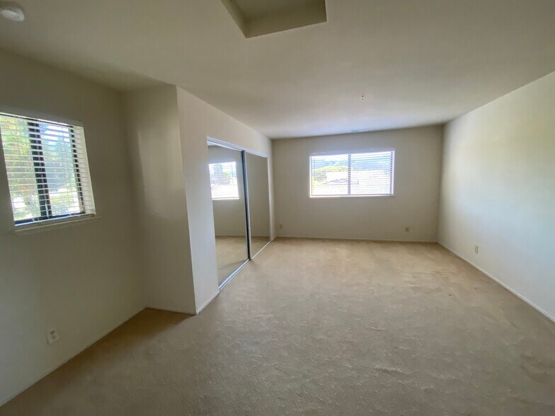 Top floor primary bedroom with mirrored closet doors and east facing hill views - 445 Willow Ave
