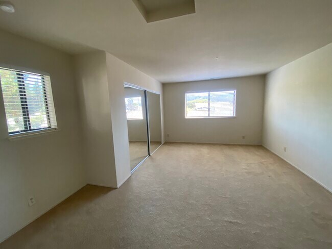 Top floor primary bedroom with mirrored closet doors and east facing hill views - 445 Willow Ave