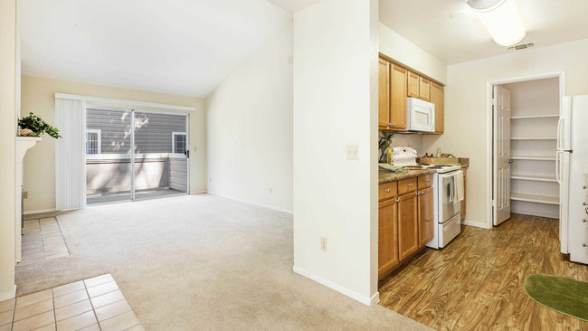 Kitchen and Carpeted Living Room with Balcony - Canyon Creek