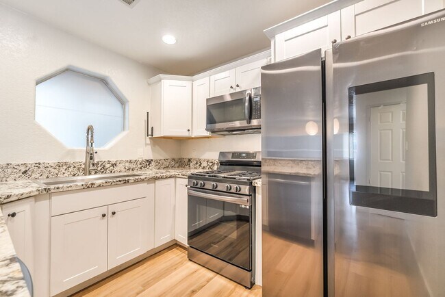 Building Photo - Upgraded Three-Bedroom Condo with Wood Flooring and Modern Comforts!