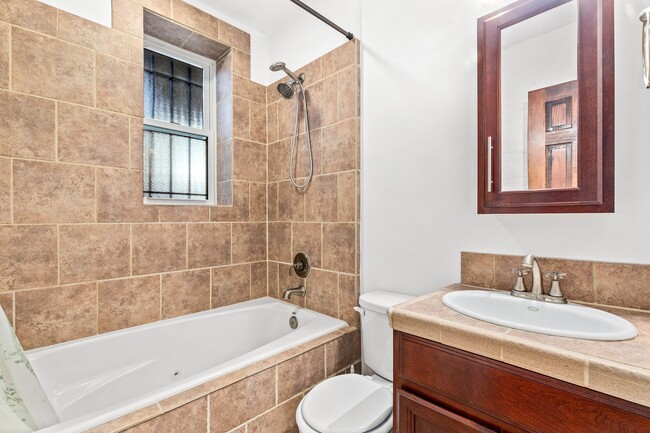 Bath with jacuzzi tub and window - 39 New York Ave NW