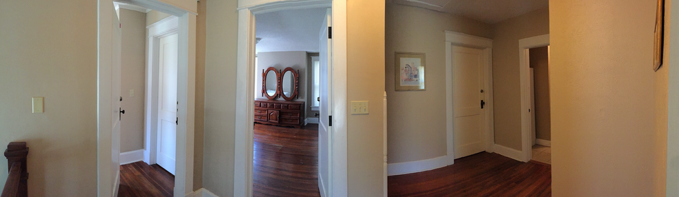 This panorama shows the three doors to bedrooms (left to right: NE, SE, and SW) and the bathroom door (on the far right). The one being advertised here is the NE bedroom. - 1525 South 7th Street