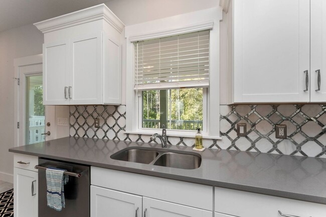 Building Photo - Introducing a captivating 3-story townhome...