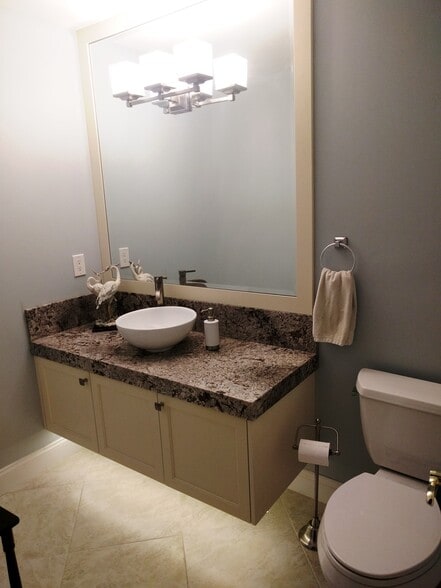Updated powder room, floating vanity, granite countertop - 2662 NW 42nd St