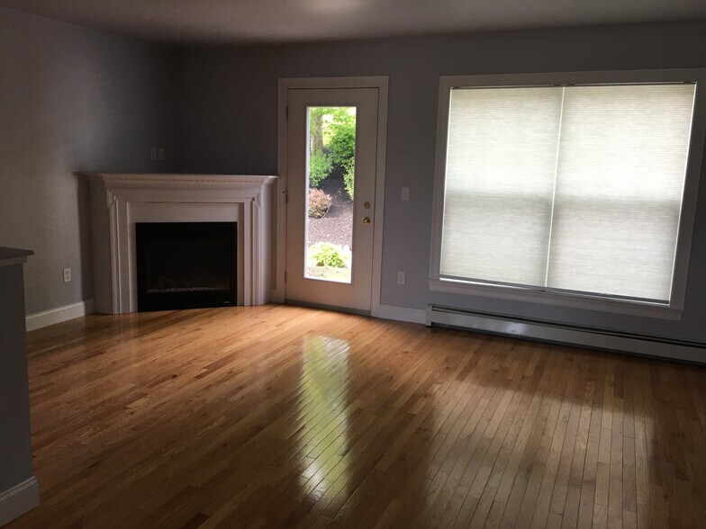 Living area with large windows and door to patio - 14 Heron Cove Dr