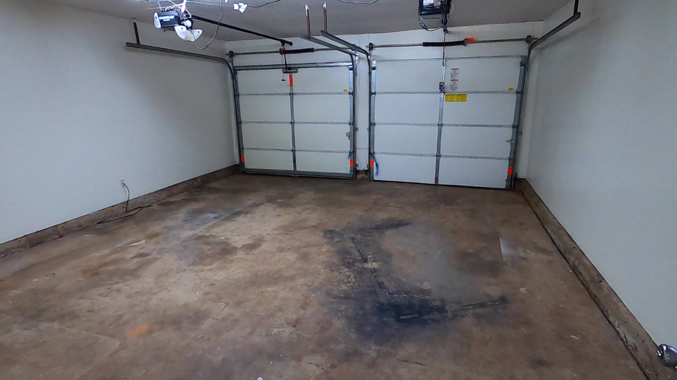 View of garage from backdoor of utility room - each opener controls both doors - 415 W Guthrie St