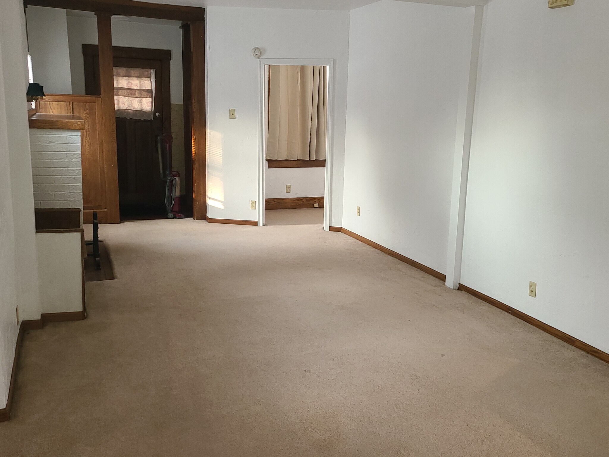 Looking towards front door. Fireplace on left. - 122 Edgerton Rd