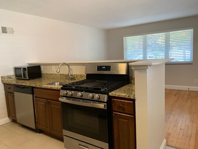 Kitchen opens to living room - 1112 Moorlands Dr