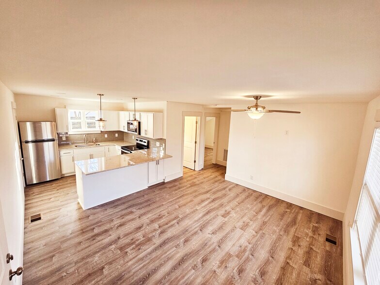 Large kitchen with granite countertops. There is storage on both sides of the island. - 1219 N 7th St