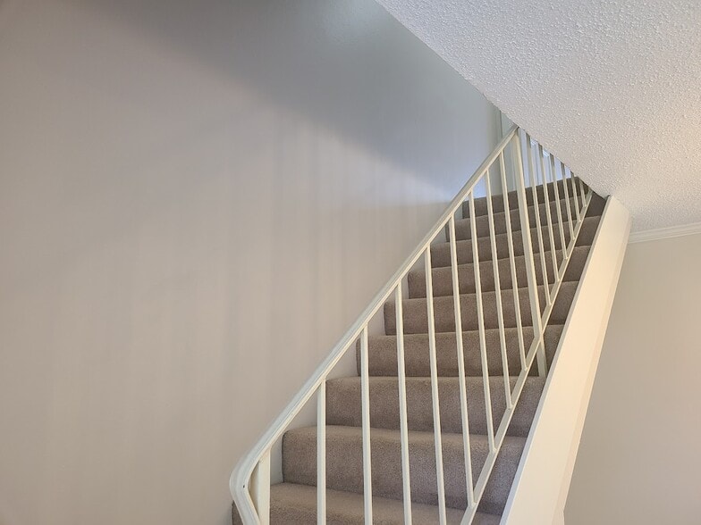 Stairs to Master Bedroom Suite that makes up entire 1/2 story - 12439 Coursey Blvd