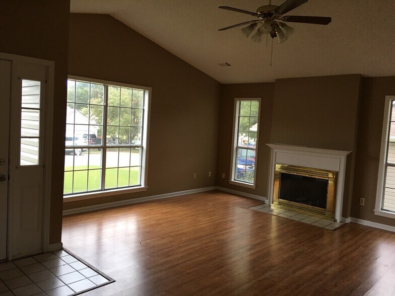 The living room is spacious and has ample natural light. - 4007 Cornerstone Dr