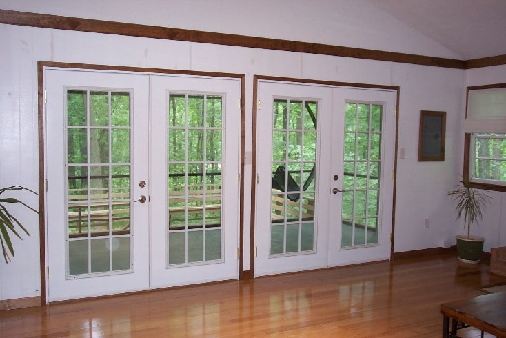 View of the screen porch and beyond from the living room. - 410 Mount Oriole Lane