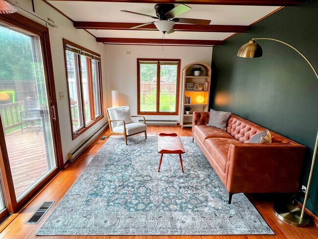 This room is cozy, sophisticated, and has great views into the backyard from the many windows. - 228 W Lexington Blvd