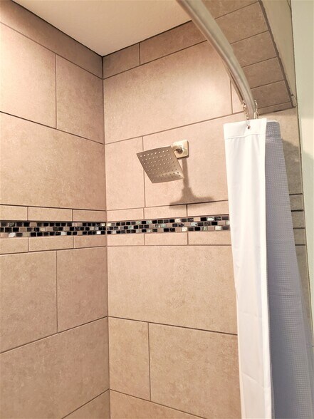 The shower is lined with Custom Tile. - 1211 Pine St