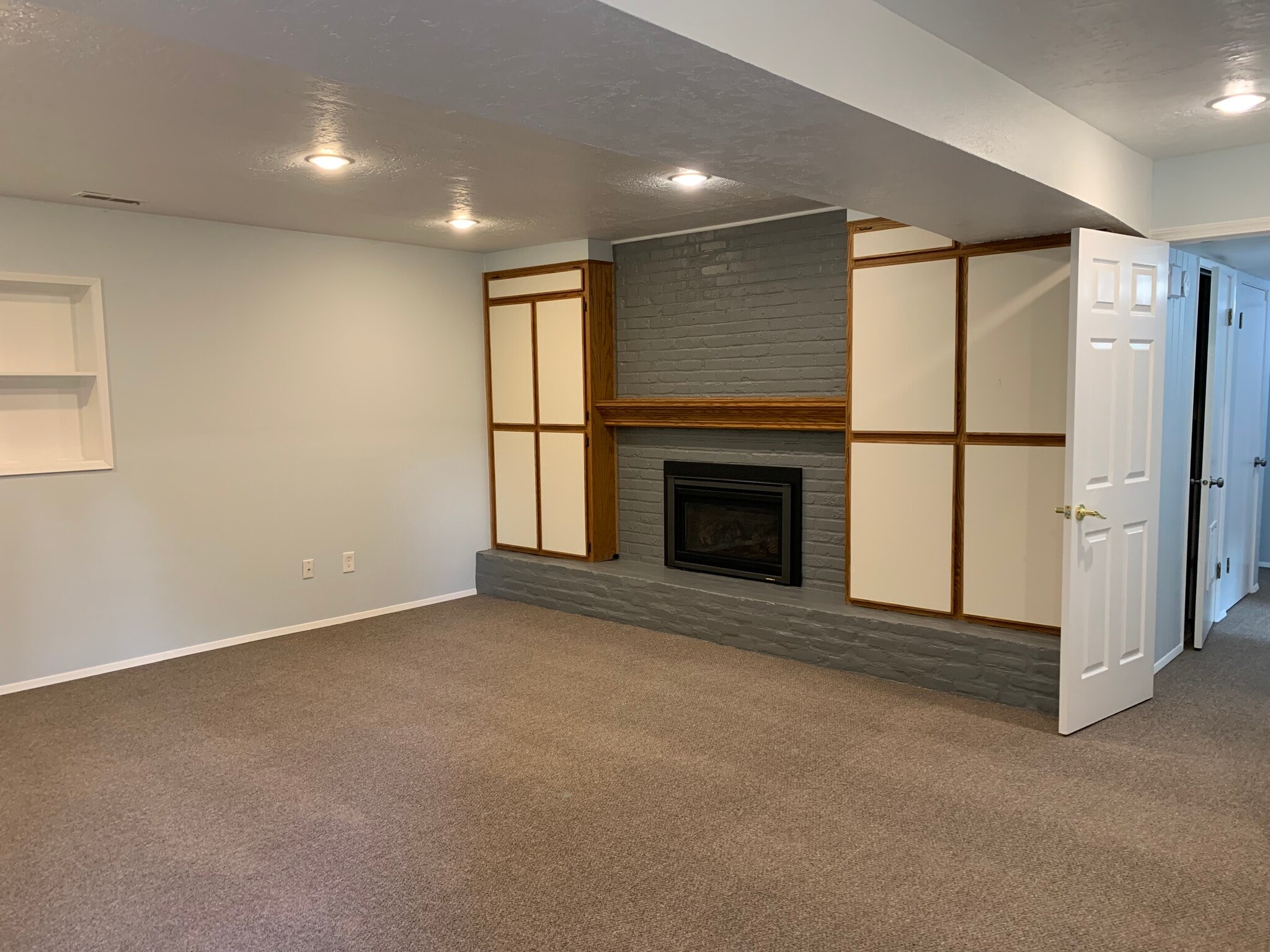 Gas fireplace in living room with enclosed bookshelves - 4135 NW Carlton Ct