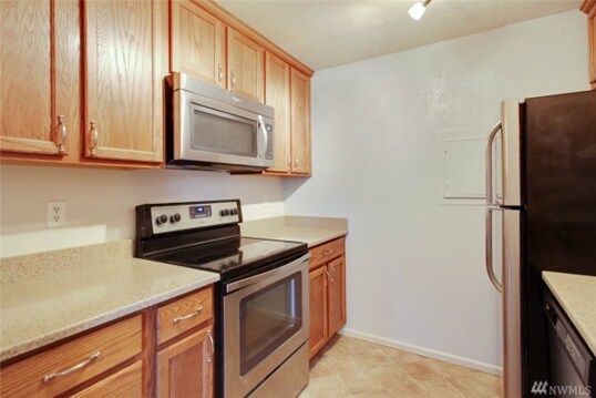 Kitchen with stainless steel appliances - 17512 149th Ave SE
