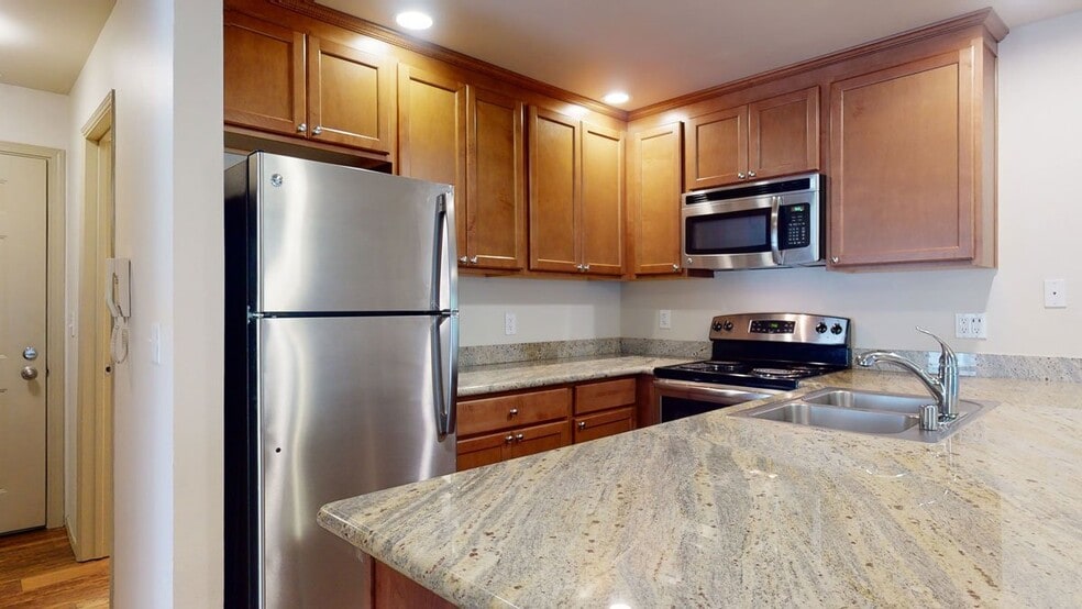 Stunning Kitchen with Stainless steel appliances, lots of counter space and cabinet storage, and a dining area. - Windsong